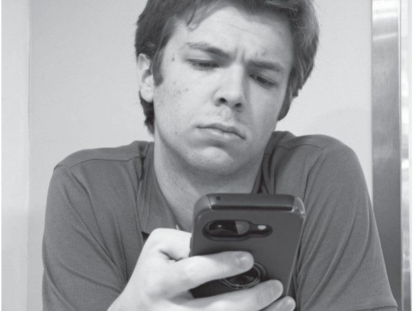 a-new-kind-of-social-network-1 A person holds and scrolls through a smartphone.