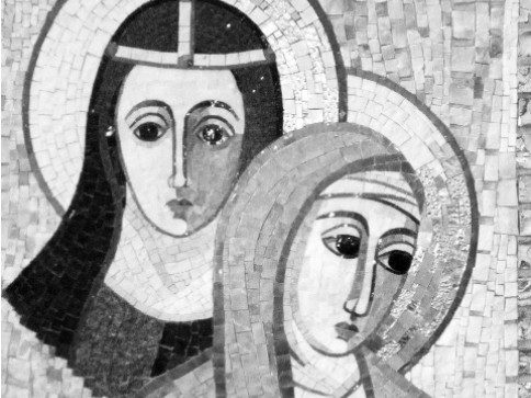 A portion of a mosaic depicting religious figures with halos rendered in fine tile work.