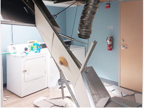 ceiling-collapses-in-jerome-laundry-room-1 Ceiling collapse in Jerome Hall laundry room with exposed ductwork.