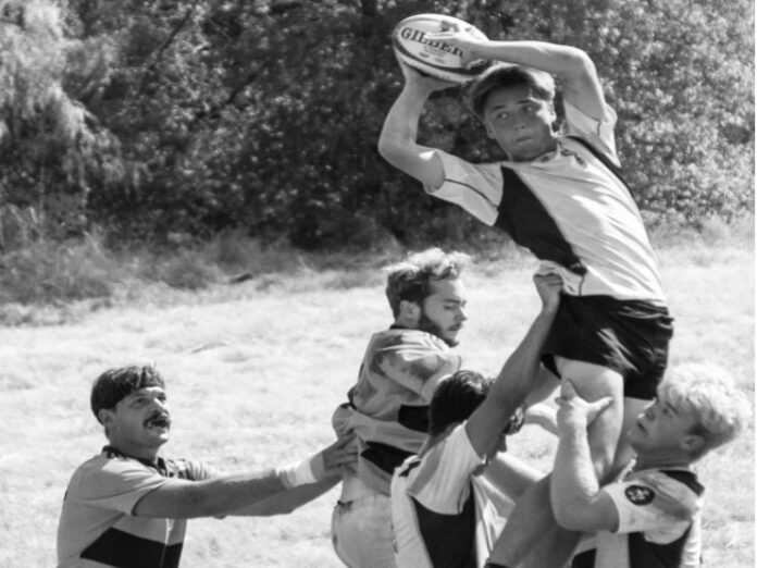 rugby-and-frisbee-teams-shine-during-afw-games-1 A UD rugby player holds a Gilbert rugby ball during play.