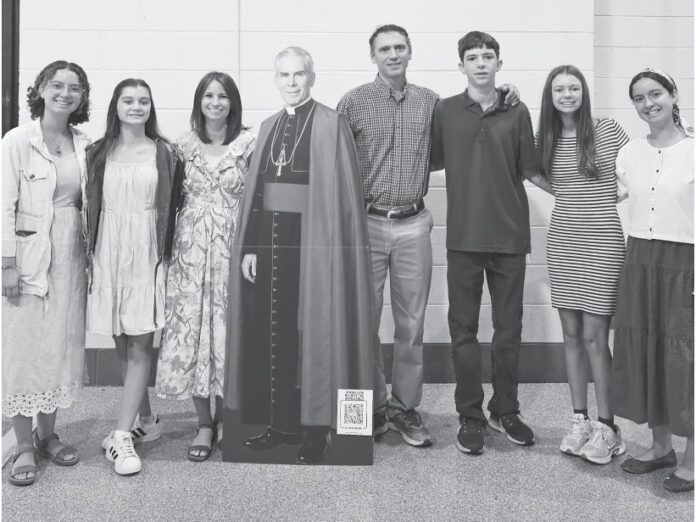 students-travel-to-st-louis-for-beatification-of-abp-sheen-1 A family group with a cardboard cutout of Fulton Sheen at his beatification