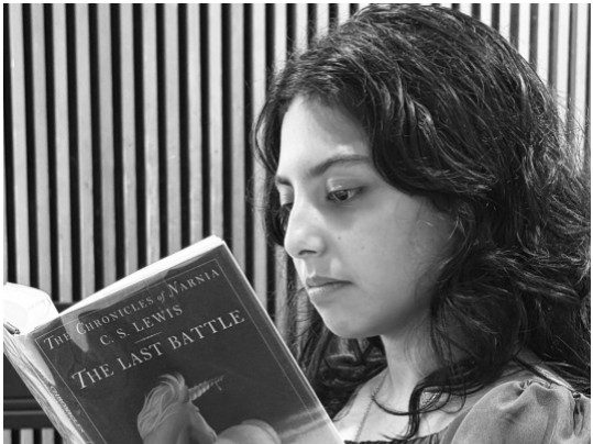 to-cite-ancient-magic-1 A student reads a Narnia book on campus.