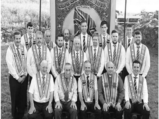trouble-in-eire-1 Members of Ireland's Orange Order in ceremonial white shirts and orange sashes march together
